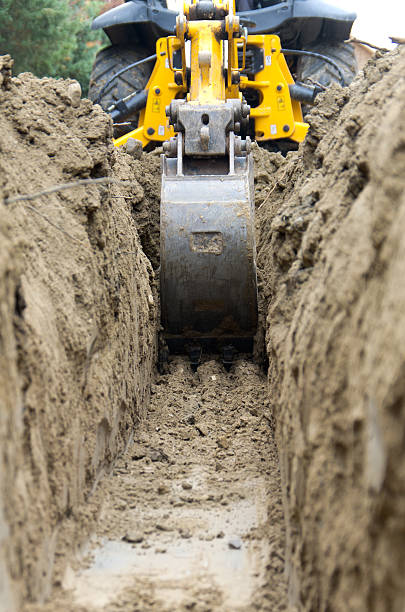 Backhoe Digging a Trench stock photo