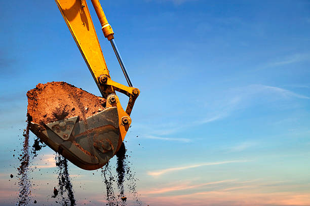 Backhoe Excavator lifting dirt. earth mover stock pictures, royalty-free photos & images