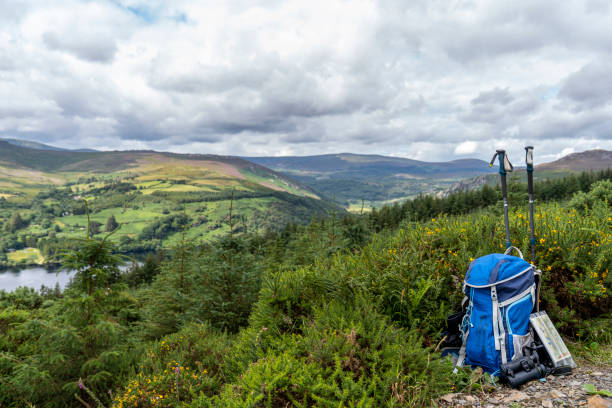 Backpack, binoculars, map and sticks on the mountain, mountain lifestyle in Ireland. stock photo