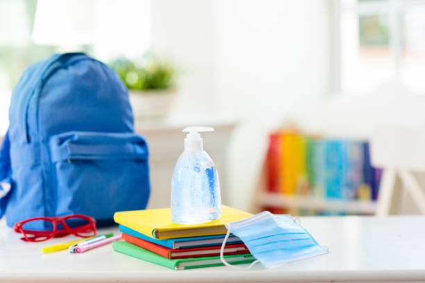 Backpack of school child. Face mask and sanitizer. Backpack of school child with face mask and sanitizer. Student safety after coronavirus pandemic. Virus and disease prevention for kids. Back to school and kindergarten after covid-19 outbreak. back to school stock pictures, royalty-free photos & images