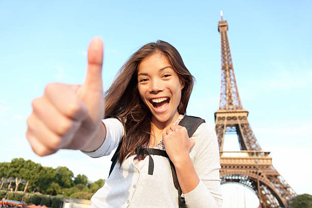 Backpacking Asian female at Eiffel Tower, Paris stock photo