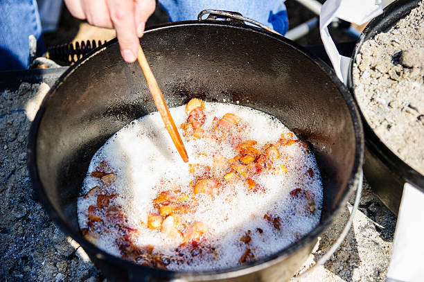 Bacon frying in a dutch oven stock photo