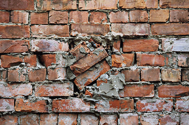 Bad repair work on a broken brickwall stock photo