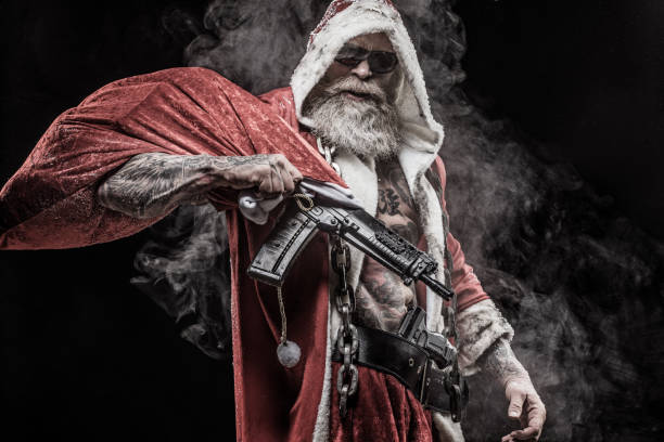 Bad Santa Claus with gun Portrait of weapon wielding tattooed bad ass Santa Claus nra stock pictures, royalty-free photos & images