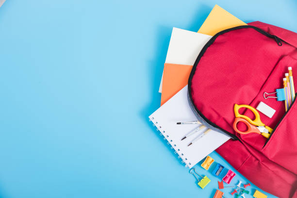 bag backpack for education children Top view Red bag backpack for education children on blue background back to school concept backpack stock pictures, royalty-free photos & images