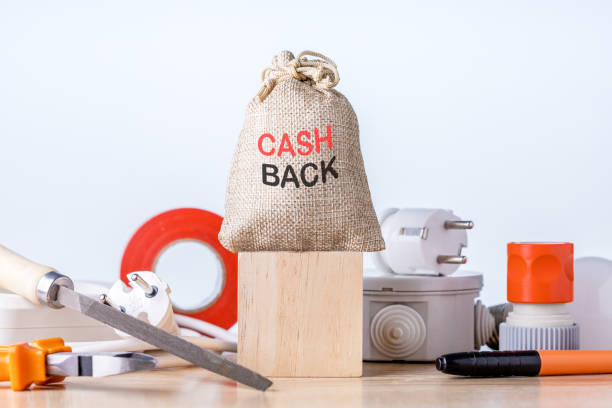 Bag with money of cash back on wooden block. stock photo