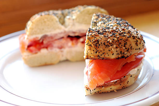 Bagel and lox Smoked salmon, cream cheese, tomato, and red onion on an "everything" bagel. Shallow DOF. smoked salmon photos stock pictures, royalty-free photos & images