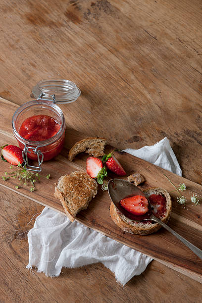 Baguette with strawberries and jam stock photo