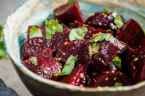 Baked beetroot salad with cilantro in a bowl. Healthy vegan food concept.