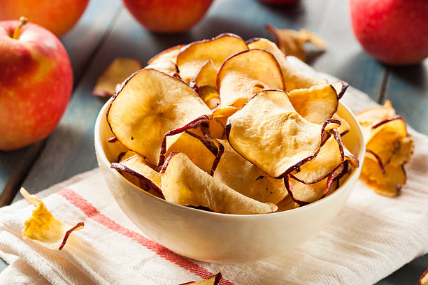 Baked Dehydrated Apples Chips Baked Dehydrated Apples Chips in a Bowl dried food photos stock pictures, royalty-free photos & images