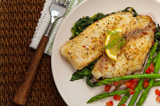 Baked Fish Fillet Whitefish with Roasted Asparagus. Selective focus. dill photos stock pictures, royalty-free photos & images