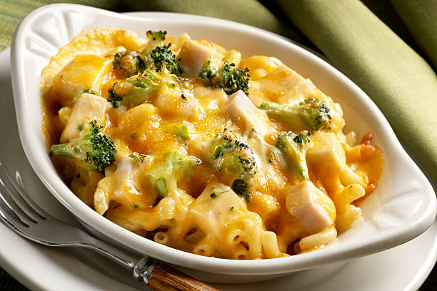 Baked Macaroni with Broccoli and Chicken Single serve casserole of baked elbow macaroni with chopped broccoli and cubed chicken breast topped with cheddar cheese and backed until hot and melted.See other Mac and Cheese casseroles from classsic to other flavor combinations in my PASTA Lightbox. burwellphotography stock pictures, royalty-free photos & images