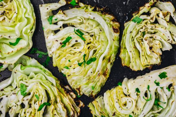 Baked or grilled white cabbage pieces Baked or grilled white cabbage pieces with parsley cabbage stock pictures, royalty-free photos & images