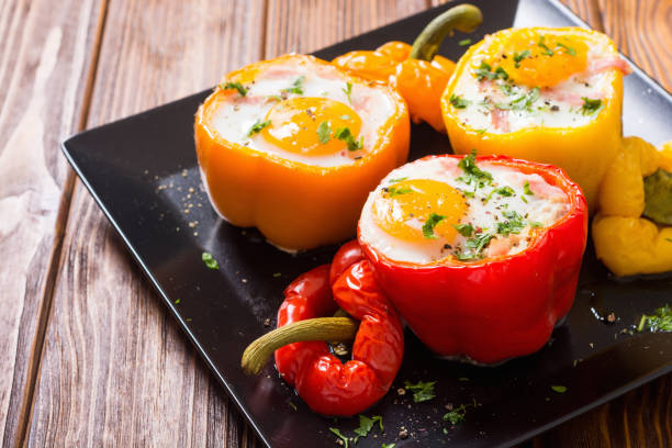 Baked pepper stuffed with bacon and eggs stock photo