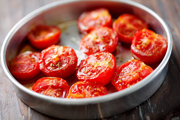 Baked tomato halves in small pan stock photo