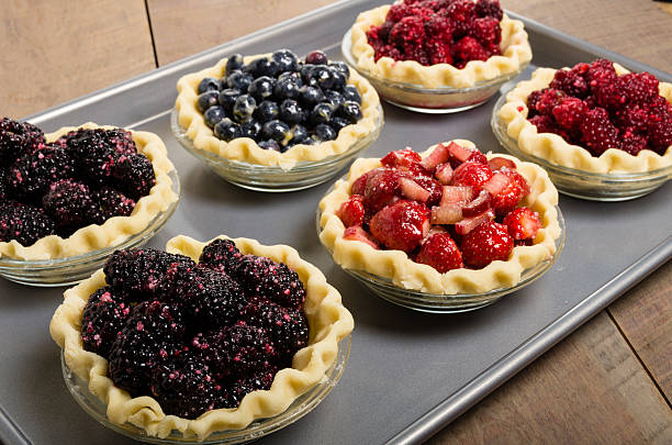 Homemade fresh fruit pies on a tray made with strawberries...