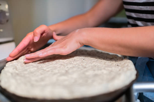 A woman's hands shaping crust 