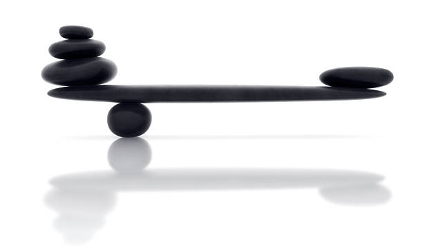 Balancing smooth black stone with reflection stock photo