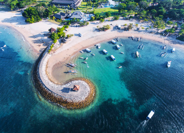 Bali coast with a figurative breakwater aerial view Bali Nusa Dua coast with a figurative breakwater aerial view bali stock pictures, royalty-free photos & images