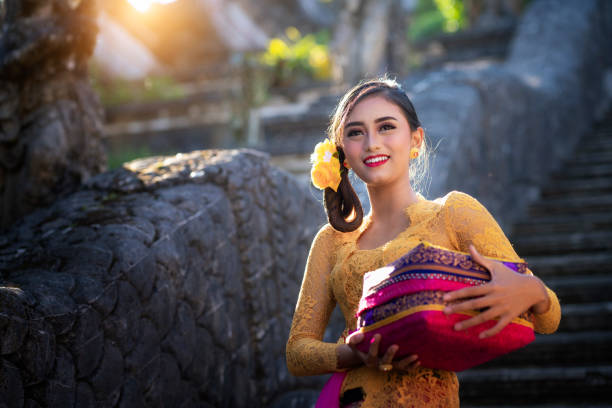 Bali Lady in Traditional dress walk in old temple Bali Lady in Traditional dress walk in old temple, indonesia indonesian woman stock pictures, royalty-free photos & images