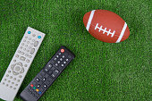 Ball for baseball and remotes from the TV on the green grass, Watch the match, live broadcast, championship. Fan. American football