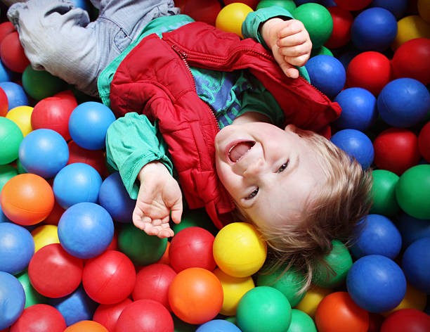 Ball pool boy  indoor playground stock pictures, royalty-free photos & images