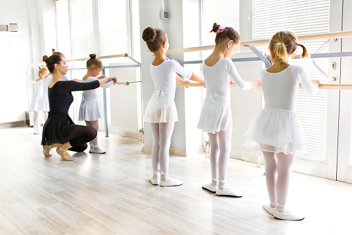Ballet Teacher Helping Girls With Postures During Ballet