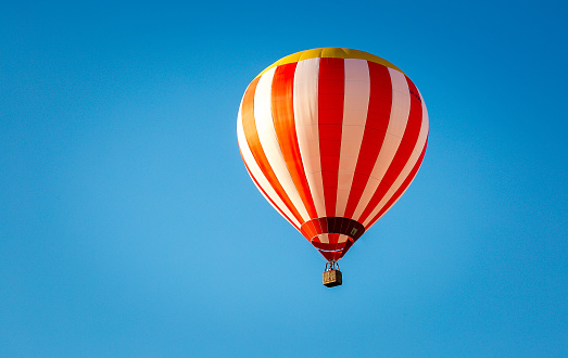 Krakow, Poland - July 11, 2020: Hot air balloon in flight against the blue sky.