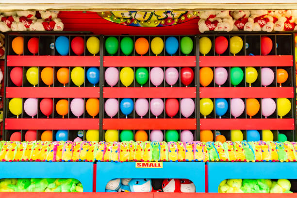 balloons and prizes at a dart throwing game booth at a carnival, fair, or amusement park stock photo