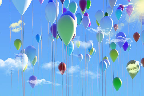 Balloons flying high in the sky stock photo