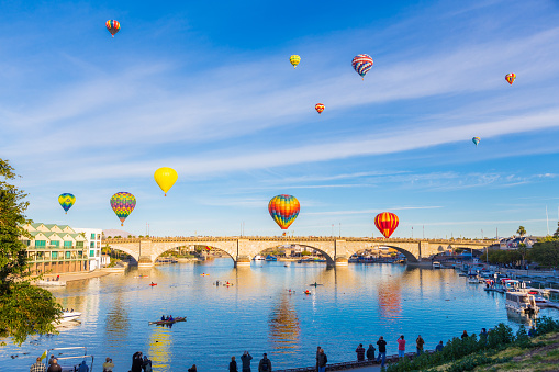 Multiple hot air balloons ascend over the London Bridge, in Lake Havasu City Arizona, during the annual the air balloon festival. 
