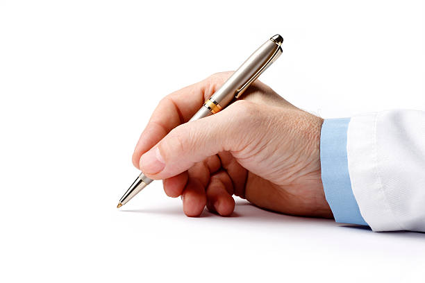 ballpoint pen in the doctor's hand on white background - recept document stockfoto's en -beelden
