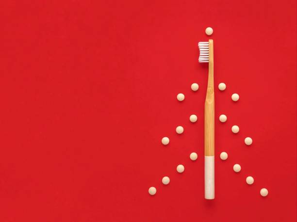 Bamboo toothbrush, eco toothpaste in tablets. Creative Christmas tree. stock photo