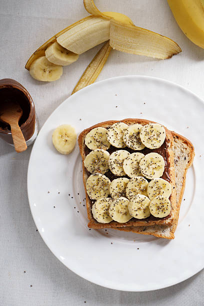banana and chia seeds toast banana and chia seeds sandwich on brown cereal bread almond butter stock pictures, royalty-free photos & images