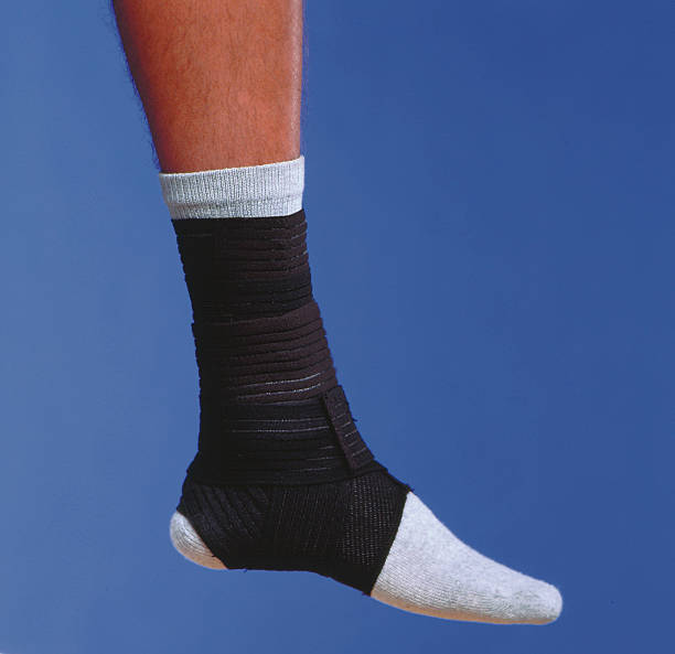 bandage wrapped ankle stock photo