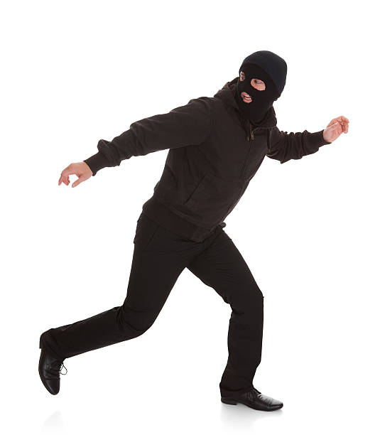 Bandit In Black Mask Running Away Man Wearing Mask Running Over White Background ski mask criminal stock pictures, royalty-free photos & images