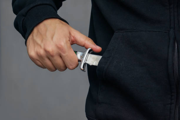 bandit pulls out his pocket folding knife to threats. stock photo
