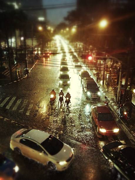 Bangkok city under tropical rain at night stock photo