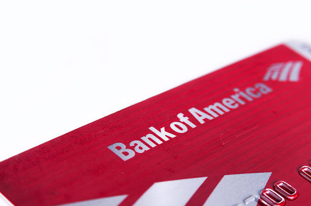 Bank of america debit card close up isolated on white Charlotte, NC, United States of America - June 26, 2015: Bank of america debit card close up on isolated on white background. Selective focus color image with shallow depth of field in horizontal orientation bank of america stock pictures, royalty-free photos & images