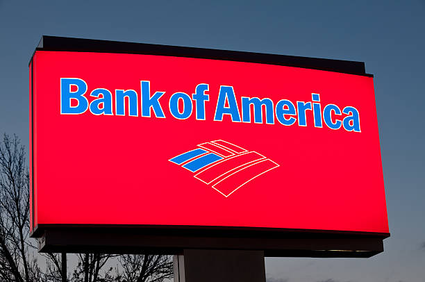 Bank of America Illuminated sign Manchester, New Hampshire, United States - April 14, 2011: This is a close up photo of a Bank of America sign at one of their banks. Illuminated at dusk. Bank of America is the largest bank in the United States. bank of america stock pictures, royalty-free photos & images