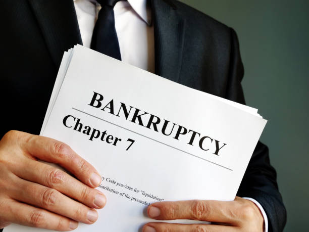 Bankruptcy Chapter 7 documents in the hands. Bankruptcy Chapter 7 documents in the hands. bankruptcy stock pictures, royalty-free photos & images