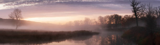 Photo of Banner panoramic autumn landscape fog over river and sky with rising sun