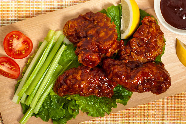 Barbecue Buffalo Chicken Breaded chicken with barbecue sauce. Selective focus. chicken thigh meat stock pictures, royalty-free photos & images