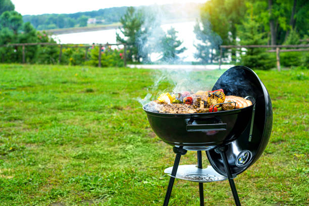 Barbecue time at the nature. BBQ grilling on the shore of a picturesque lake. Copy space. Barbecue time at the nature. BBQ grilling on the shore of a picturesque lake. Copy space. barbecue stock pictures, royalty-free photos & images