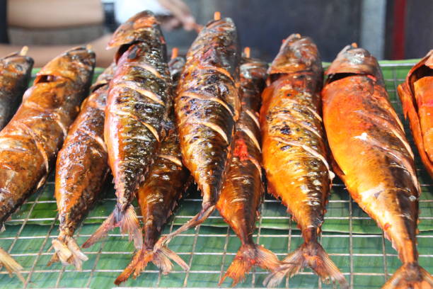 Barbecued fish for sale Barbecued fish for sale on a market stall in Thailand. colin fish stock pictures, royalty-free photos & images