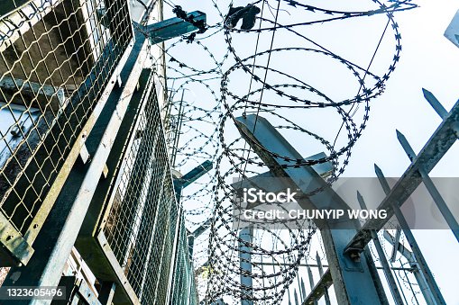istock Barbed wire on the fence. Protective fencing specially protected 1323605496