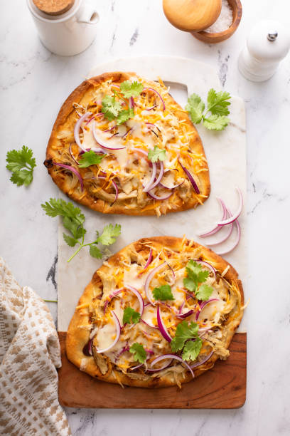 Barbeque chicken flatbread with cheese and red onion Barbeque chicken flatbread with BBQ sauce, cheese and red onion naan bread stock pictures, royalty-free photos & images