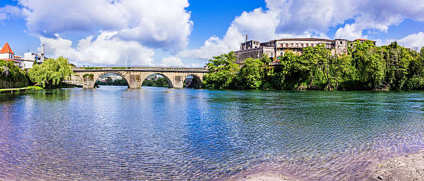 Barcelos bridge and the river Cávado Barcelos romanesque bridge in Portugal over the river Cávado. This panoramic view of an historic site with archeological findings towards the right side of the bridge. barcelos stock pictures, royalty-free photos & images