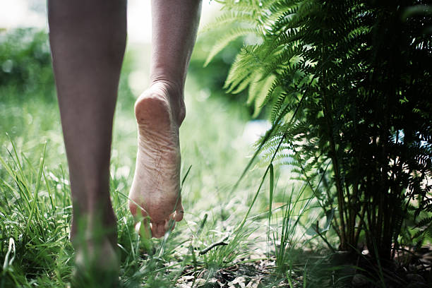 Barefoot Young woman walking barefoot stock pictures, royalty-free photos & images