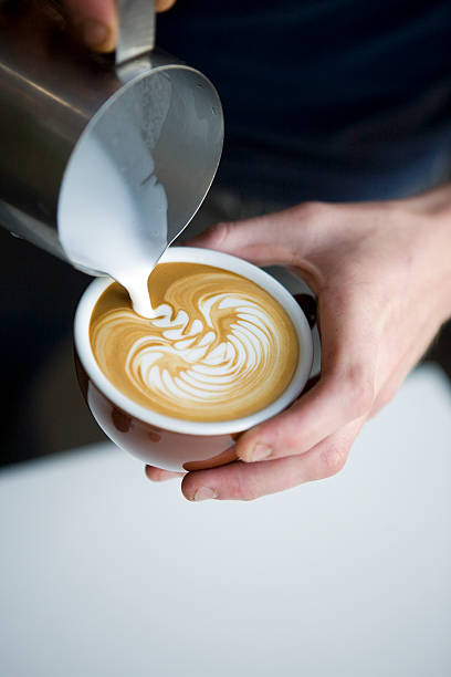 Barista pouring latte - coffee stock photo